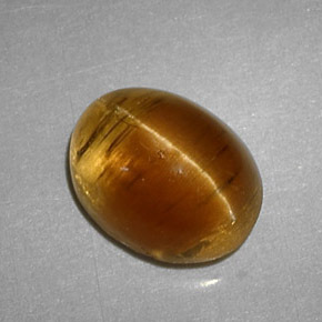 Cat's Eye Apatite طبيعي بلون عسلي، وزن ‎3.32‎ قيراط، شكل بيضاوى، مقاس ‎9.3x7.2‎ مم