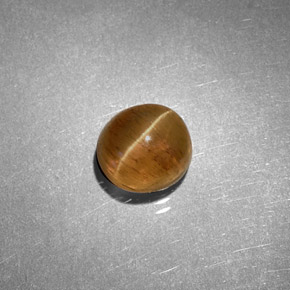 Cat's Eye Apatite طبيعي بلون عسلي، وزن ‎1.61‎ قيراط، شكل بيضاوى، مقاس ‎6.2x5.7‎ مم