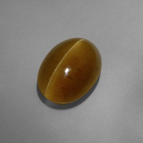 Cat's Eye Apatite طبيعي بلون ذهبي مخضر، وزن ‎8.32‎ قيراط، شكل شفاف، مقاس ‎14x10.1‎ مم