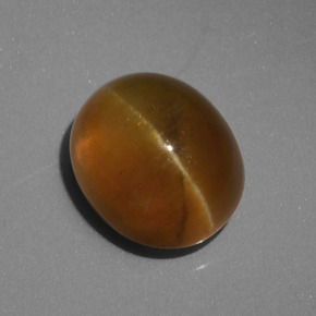 أباتيت عين القط أخضر ذهبى طبيعي، قصة بيضاوى، 4.62 قيراط، نصف شفاف