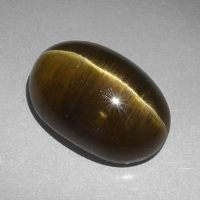 Cat's Eye Apatite طبيعي بلون بني ذهبي، وزن ‎20.30‎ قيراط، شكل بيضاوى، مقاس ‎19x13‎ مم