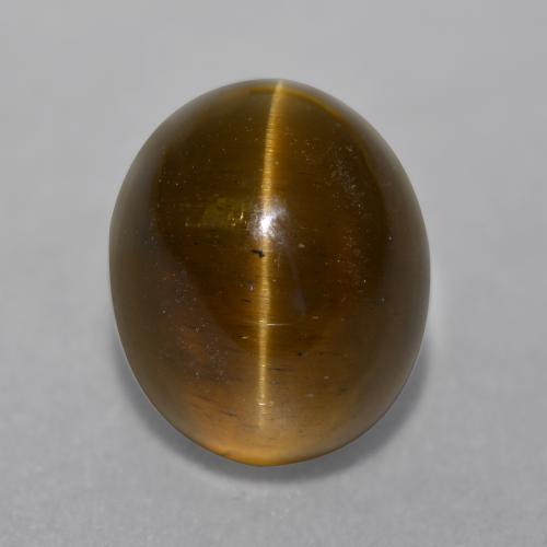 Cat's Eye Apatite طبيعي بلون برتقالي بني عميق، وزن ‎7.22‎ قيراط، شكل بيضاوى، مقاس ‎11.4x9.4‎ مم