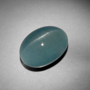 Cat's Eye Aquamarine طبيعي بلون أزرق-أخضر، وزن ‎12.46‎ قيراط، شكل بيضاوى، مقاس ‎15.8x11.6‎ مم