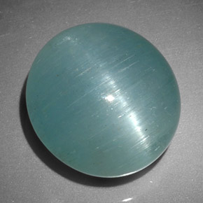 Cat's Eye Aquamarine طبيعي بلون أزرق-أخضر، وزن ‎12.01‎ قيراط، شكل بيضاوى، مقاس ‎14.4x13.4‎ مم