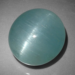 Cat's Eye Aquamarine طبيعي بلون أزرق-أخضر، وزن ‎12.01‎ قيراط، شكل بيضاوى، مقاس ‎14.4x13.4‎ مم