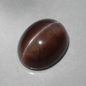 Cat's Eye Scapolite طبيعي بلون بني داكن، وزن ‎5.30‎ قيراط، شكل بيضاوى، مقاس ‎12.1x9.6‎ مم