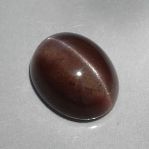 Cat's Eye Scapolite طبيعي بلون بني داكن، وزن ‎5.30‎ قيراط، شكل بيضاوى، مقاس ‎12.1x9.6‎ مم