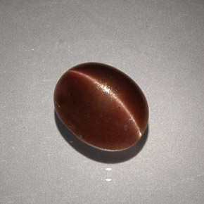 Cat's Eye Scapolite طبيعي بلون بني، وزن ‎2.56‎ قيراط، شكل بيضاوى، مقاس ‎9.1x7.3‎ مم