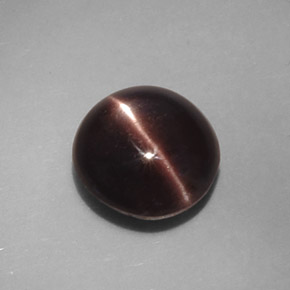 Cat's Eye Scapolite طبيعي بلون بني داكن، وزن ‎3.46‎ قيراط، شكل بيضاوى، مقاس ‎9.4x8.9‎ مم