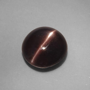 Cat's Eye Scapolite طبيعي بلون بني داكن، وزن ‎3.46‎ قيراط، شكل بيضاوى، مقاس ‎9.4x8.9‎ مم