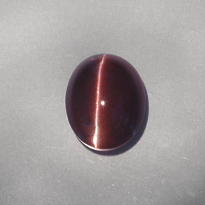 Cat's Eye Scapolite طبيعي بلون بني داكن، وزن ‎4.26‎ قيراط، شكل بيضاوى، مقاس ‎11.1x8.8‎ مم