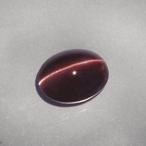 Cat's Eye Scapolite طبيعي بلون بني داكن، وزن ‎4.26‎ قيراط، شكل بيضاوى، مقاس ‎11.1x8.8‎ مم