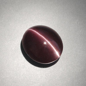 Cat's Eye Scapolite طبيعي بلون بني داكن، وزن ‎4.00‎ قيراط، شكل بيضاوى، مقاس ‎10.6x9.1‎ مم