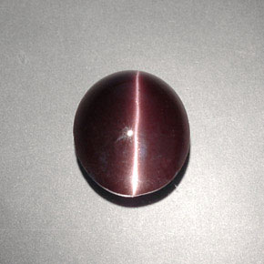 Cat's Eye Scapolite طبيعي بلون بني داكن، وزن ‎4.00‎ قيراط، شكل بيضاوى، مقاس ‎10.6x9.1‎ مم