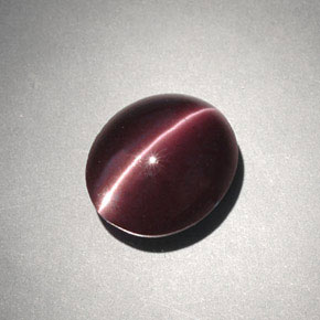 Cat's Eye Scapolite طبيعي بلون بني داكن، وزن ‎4.00‎ قيراط، شكل بيضاوى، مقاس ‎10.6x9.1‎ مم