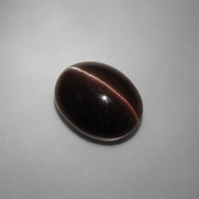 Cat's Eye Scapolite طبيعي بلون بني داكن، وزن ‎6.90‎ قيراط، شكل بيضاوى، مقاس ‎13.2x10.3‎ مم
