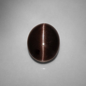 Cat's Eye Scapolite طبيعي بلون بني داكن، وزن ‎6.90‎ قيراط، شكل بيضاوى، مقاس ‎13.2x10.3‎ مم
