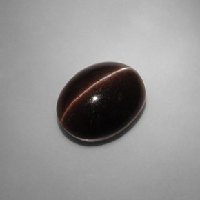 Cat's Eye Scapolite طبيعي بلون بني داكن، وزن ‎6.90‎ قيراط، شكل بيضاوى، مقاس ‎13.2x10.3‎ مم