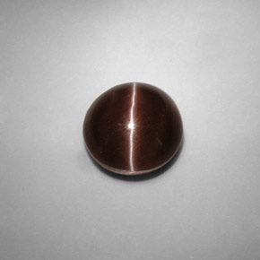 Cat's Eye Scapolite طبيعي بلون بني داكن، وزن ‎5.82‎ قيراط، شكل دائري، مقاس ‎10.58‎ مم