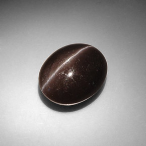 Cat's Eye Scapolite طبيعي بلون بني داكن، وزن ‎8.66‎ قيراط، شكل بيضاوى، مقاس ‎13.6x11.1‎ مم