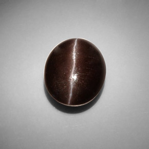 Cat's Eye Scapolite طبيعي بلون بني داكن، وزن ‎8.66‎ قيراط، شكل بيضاوى، مقاس ‎13.6x11.1‎ مم