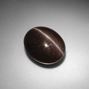 Cat's Eye Scapolite طبيعي بلون بني داكن، وزن ‎8.66‎ قيراط، شكل بيضاوى، مقاس ‎13.6x11.1‎ مم