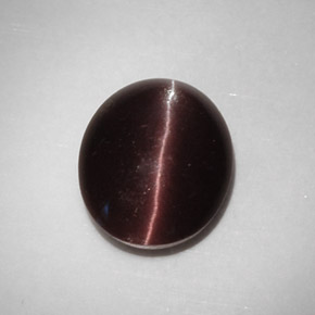 Cat's Eye Scapolite طبيعي بلون بني داكن، وزن ‎5.88‎ قيراط، شكل بيضاوى، مقاس ‎12.9x10.7‎ مم