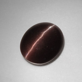 Cat's Eye Scapolite طبيعي بلون بني داكن، وزن ‎5.88‎ قيراط، شكل بيضاوى، مقاس ‎12.9x10.7‎ مم