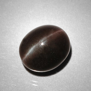 Cat's Eye Scapolite طبيعي بلون بني داكن، وزن ‎5.85‎ قيراط، شكل بيضاوى، مقاس ‎10.5x9‎ مم