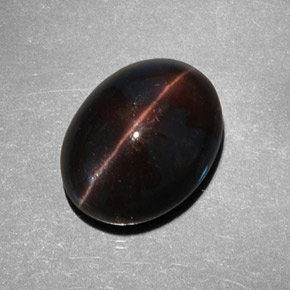 Cat's Eye Scapolite طبيعي بلون بني داكن، وزن ‎9.21‎ قيراط، شكل بيضاوى، مقاس ‎14.6x11.5‎ مم