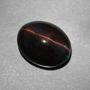 Cat's Eye Scapolite طبيعي بلون بني داكن، وزن ‎9.21‎ قيراط، شكل بيضاوى، مقاس ‎14.6x11.5‎ مم