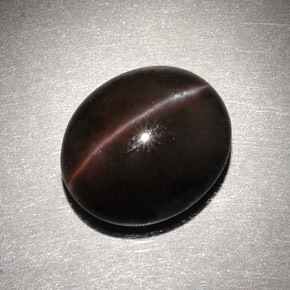 Cat's Eye Scapolite طبيعي بلون بني داكن، وزن ‎6.82‎ قيراط، شكل بيضاوى، مقاس ‎13x11.2‎ مم