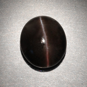 Cat's Eye Scapolite طبيعي بلون بني داكن، وزن ‎6.82‎ قيراط، شكل بيضاوى، مقاس ‎13x11.2‎ مم