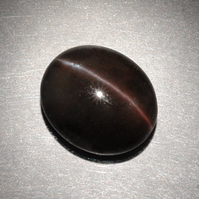 Cat's Eye Scapolite طبيعي بلون بني داكن، وزن ‎6.82‎ قيراط، شكل بيضاوى، مقاس ‎13x11.2‎ مم