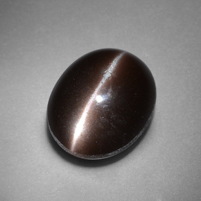 Cat's Eye Scapolite طبيعي بلون بني داكن، وزن ‎4.41‎ قيراط، شكل بيضاوى، مقاس ‎11.3x9.3‎ مم