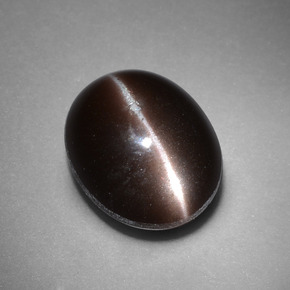Cat's Eye Scapolite طبيعي بلون بني داكن، وزن ‎4.41‎ قيراط، شكل بيضاوى، مقاس ‎11.3x9.3‎ مم
