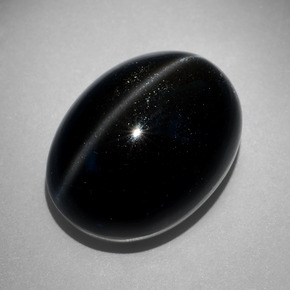 Cat's Eye Scapolite طبيعي بلون أسود، وزن ‎27.68‎ قيراط، شكل بيضاوى، مقاس ‎20.9x15.9‎ مم