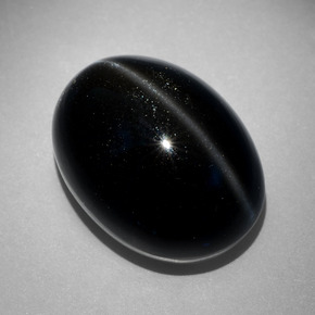 Cat's Eye Scapolite طبيعي بلون أسود، وزن ‎27.68‎ قيراط، شكل بيضاوى، مقاس ‎20.9x15.9‎ مم