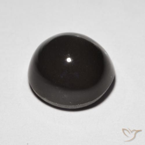Cat's Eye Scapolite طبيعي بلون بنى مسود، وزن ‎3.32‎ قيراط، شكل بيضاوى، مقاس ‎8.9x8.3‎ مم
