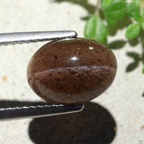 Cat's Eye Scapolite طبيعي بلون برتقالي بني عميق، وزن ‎4.55‎ قيراط، شكل بيضاوى، مقاس ‎10.7x7.9‎ مم