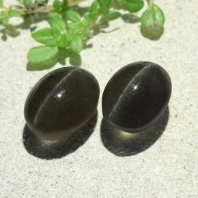 Cat's Eye Scapolite طبيعي بلون رمادي داكن، وزن ‎7.38‎ قيراط، شكل بيضاوى، مقاس ‎9.9x7.5‎ مم
