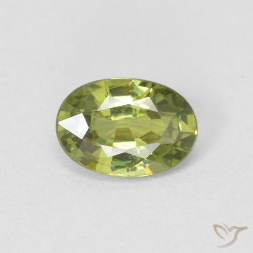 0.60ct طبيعي Medium Light Green عقيق الديمانتويد, بيضوي, قليلا جدا