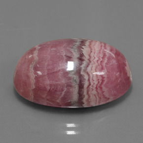 رودوكروسيت طبيعي بلون متعدد الألوان، وزن ‎33.91‎ قيراط، شكل بيضاوى، مقاس ‎23x16.1‎ مم