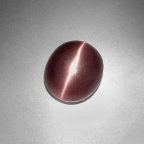 Sillimanite Cat's Eye طبيعي بلون بني أرجواني، وزن ‎3.29‎ قيراط، شكل بيضاوى، مقاس ‎9.9x8.4‎ مم
