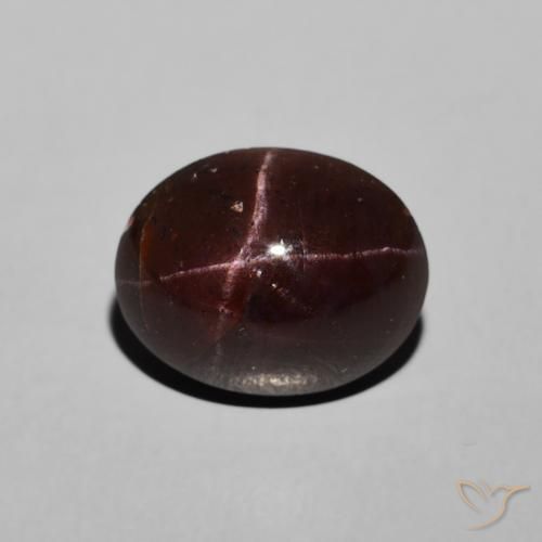 6.48ct طبيعي احمر غامق عقيق نجمى, بيضوي, غير شفاف