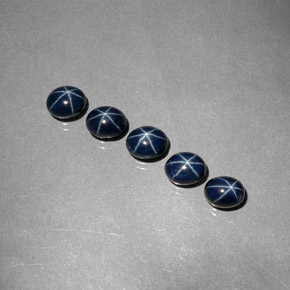 أحجار نجمة الياقوت ازرق غامق طبيعية، قصة بيضاوى، غير شفاف، وزنها  قيراط