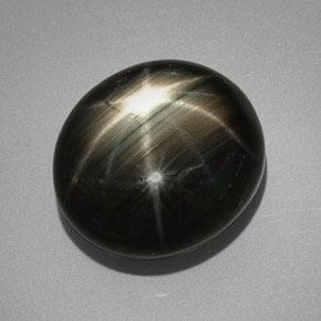 ياقوت أزرق نجمي طبيعي بلون Silver Black، وزن ‎32.25‎ قيراط، شكل بيضاوى، مقاس ‎18.4x16.5‎ مم