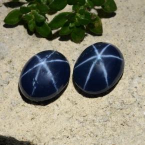 أحجار نجمة الياقوت ازرق غامق طبيعية، قصة بيضاوى، غير شفاف، وزنها 5.09 قيراط