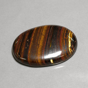 Tiger's Eye Matrix طبيعي بلون متعدد الألوان، وزن ‎43.53‎ قيراط، شكل بيضاوى، مقاس ‎31x22.3‎ مم