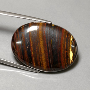 Tiger's Eye Matrix طبيعي بلون متعدد الألوان، وزن ‎43.53‎ قيراط، شكل بيضاوى، مقاس ‎31x22.3‎ مم